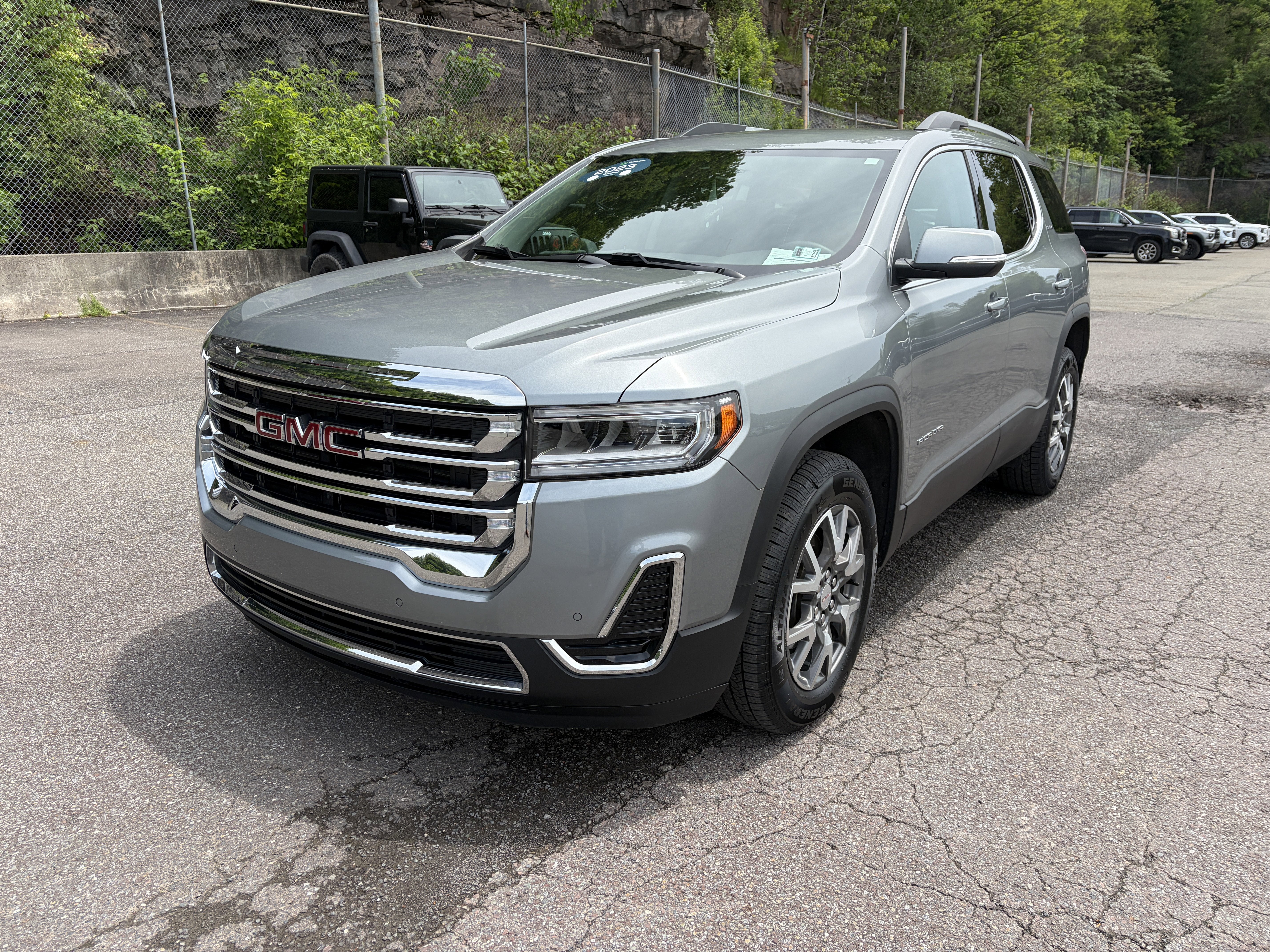 2023 GMC Acadia SLE in Sterling Metallic — front three-quarter view